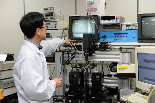ETRI 김진태 박사가 이번에 개발된 광소자의 형상을 현미경으로 관찰하고 있다.
