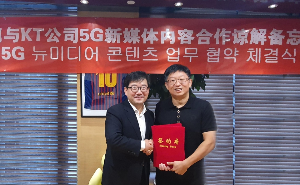 KT 뉴미디어사업단 김훈배 단장(왼쪽)과 차이나모바일 미구 류신(Liu Xin)’ 대표(오른쪽)가 협약서에 서명한 후 기념촬영하고 있다.