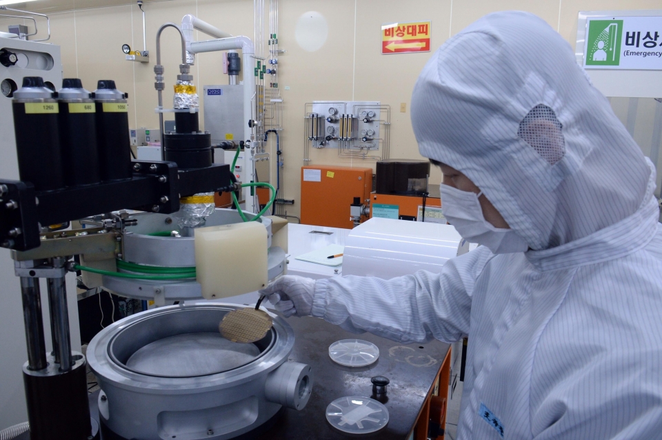 ETRI 연구진이 질화갈륨 전력소자 칩의 제작공정 중 반도체 웨이퍼를 들고 있는 모습