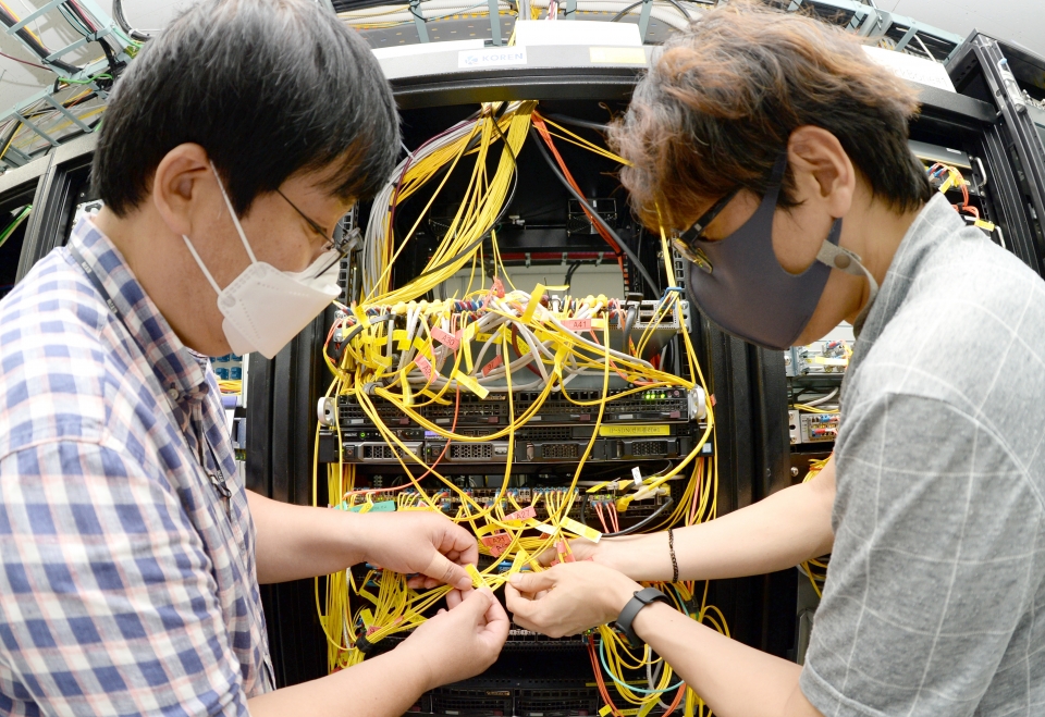 ETRI 연구진이 국가연구개발망(KOREN)에 데이터 중심 네트워킹 기술을 실증하고 있 는 모습(왼쪽에서부터 김호건 연구원, 신용윤 연구원)